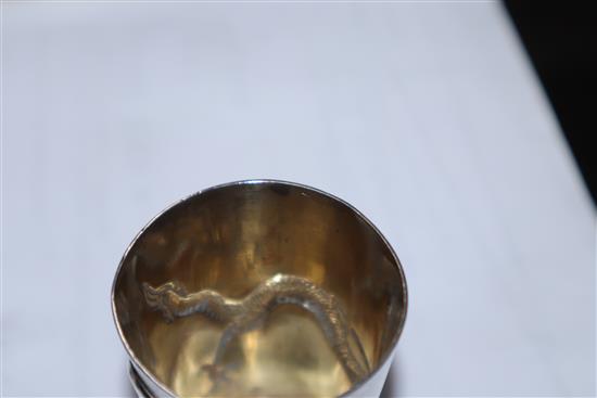 A set of nine early 20th century Chinese Export white metal tots, by Zee Wo, each decorated with a dragon, 13 oz.